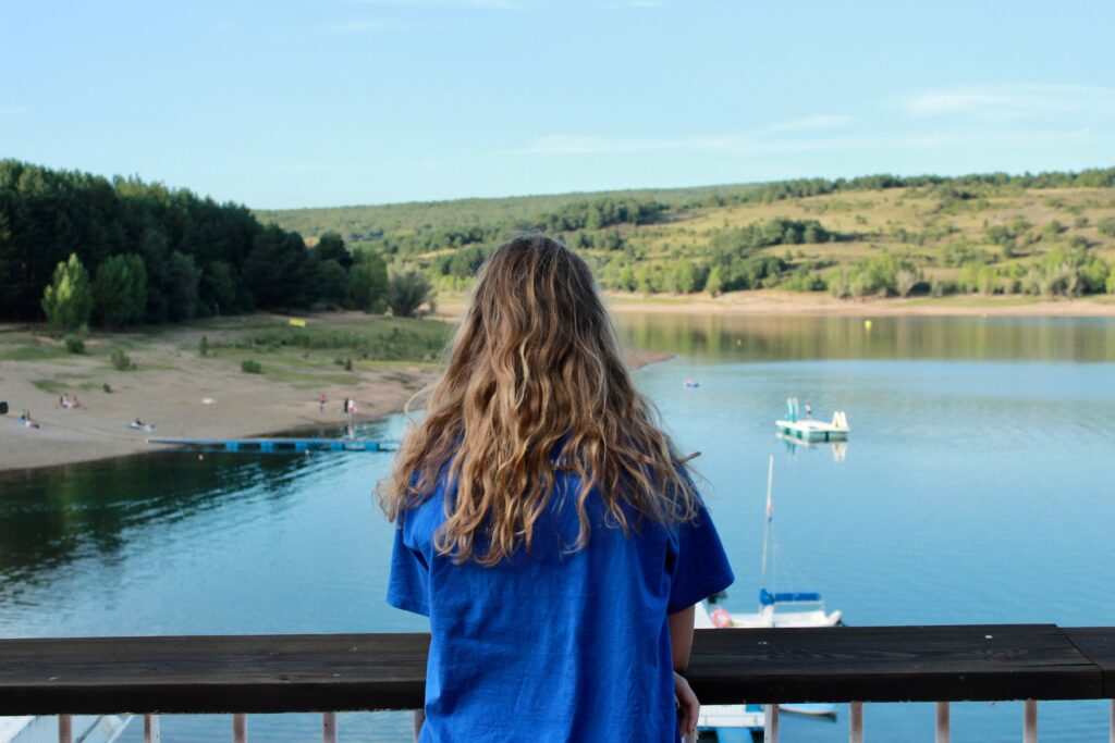 Blonde Girl Enjoying Serene Summer View in Reservoir González-Lacasa, La Rioja, Spain